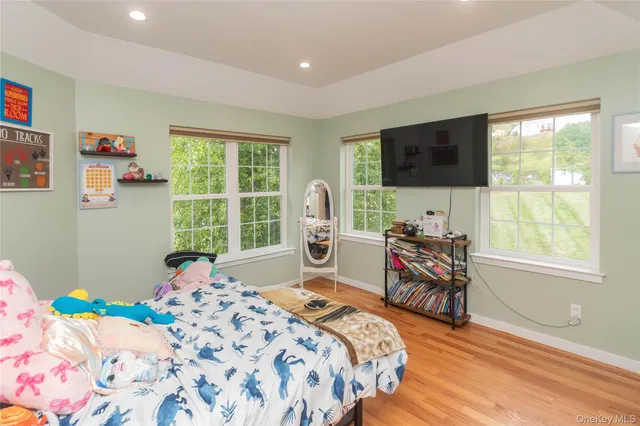 a bed sitting in a bedroom next to a window