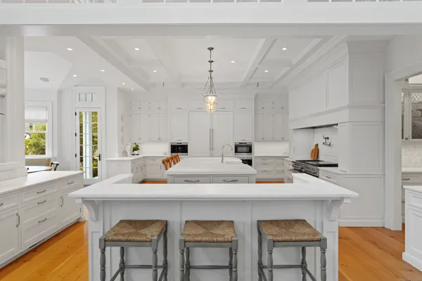 a kitchen with appliances a sink cabinets and wooden floor