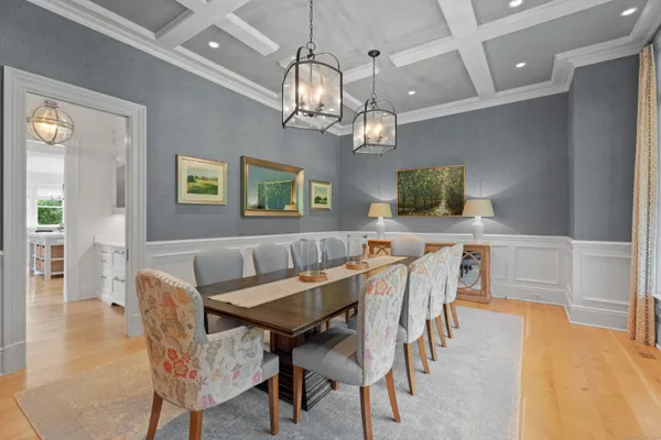 a view of a dining room with furniture and a chandelier