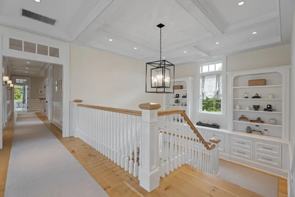 a view of a hallway with chandelier