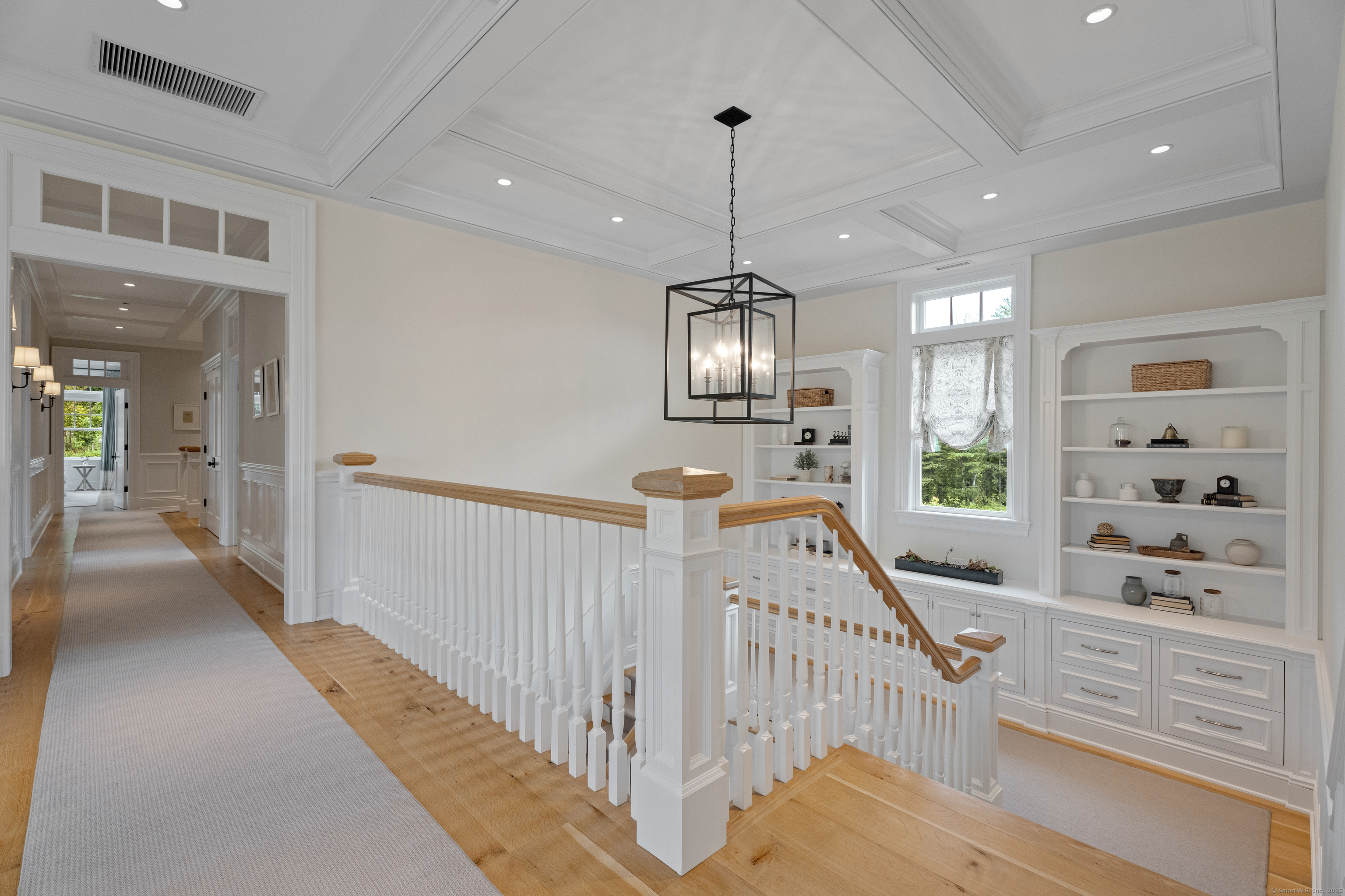 294 Maple Road Easton, CT 06612 - Photo 21 of 40 a view of a hallway with chandelier