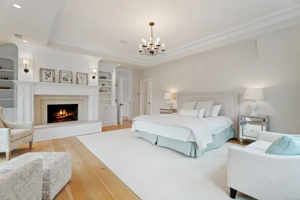 a spacious bedroom with a bed and a fireplace