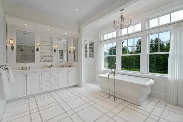 a large bathroom with a large tub shower and sink