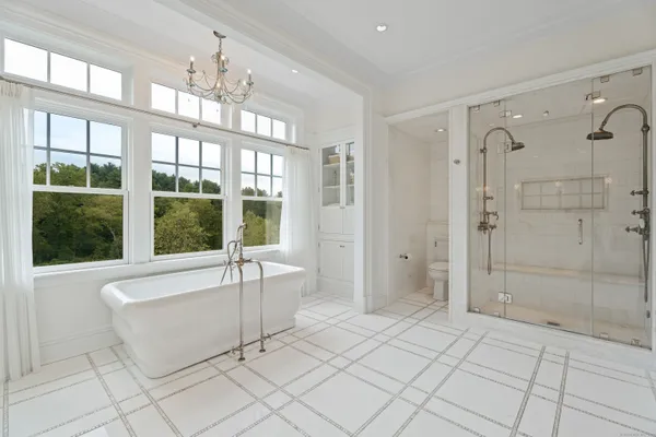 a spacious bathroom with a granite countertop bathtub and shower