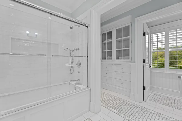 a bathroom with a bathtub and a shower