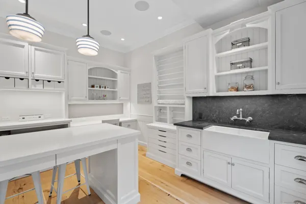 a kitchen with granite countertop a sink a stove and cabinets