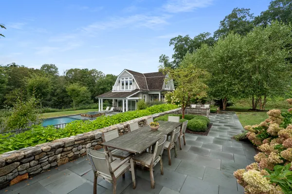 a view of an house with backyard and sitting area