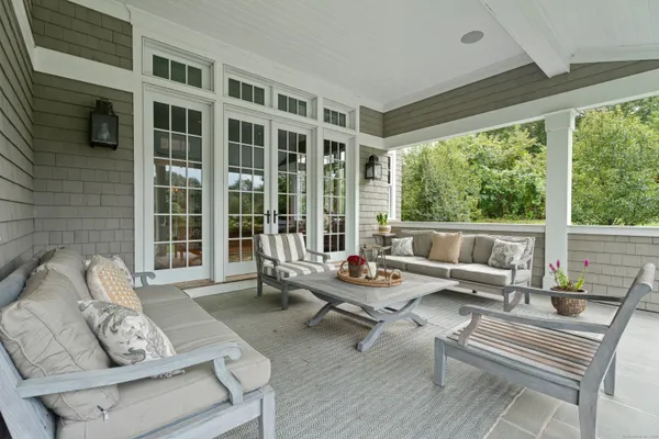 a living room with furniture and floor to ceiling windows