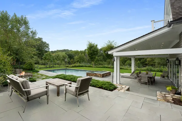 a backyard of a house with yard barbeque oven and outdoor seating