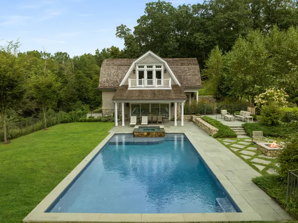 a view of a house with swimming pool and sitting area