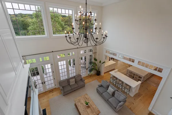 a view of living room filled with furniture and a chandelier