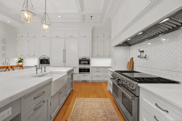 a large kitchen with stainless steel appliances granite countertop a lot of counter space