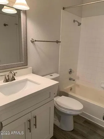 a bathroom with a sink toilet vanity and shower