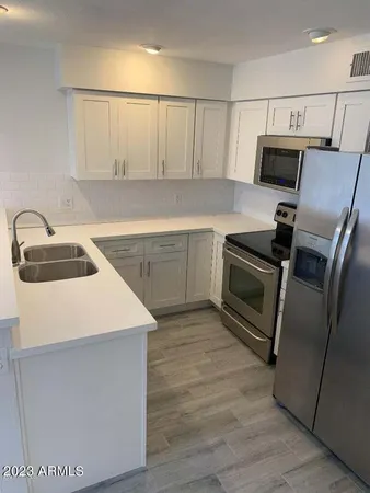 a kitchen with a sink and a refrigerator