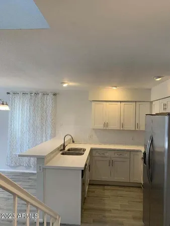 a kitchen with a sink and refrigerator