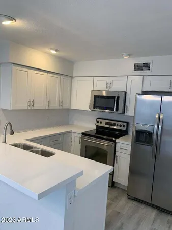 a kitchen with a sink a stove and refrigerator