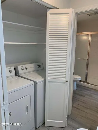 a view of washer and dryer with wooden floor