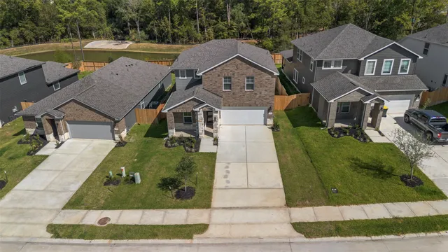 an aerial view of residential houses with outdoor space and street view