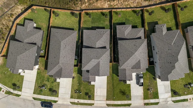 an aerial view of residential houses with outdoor space