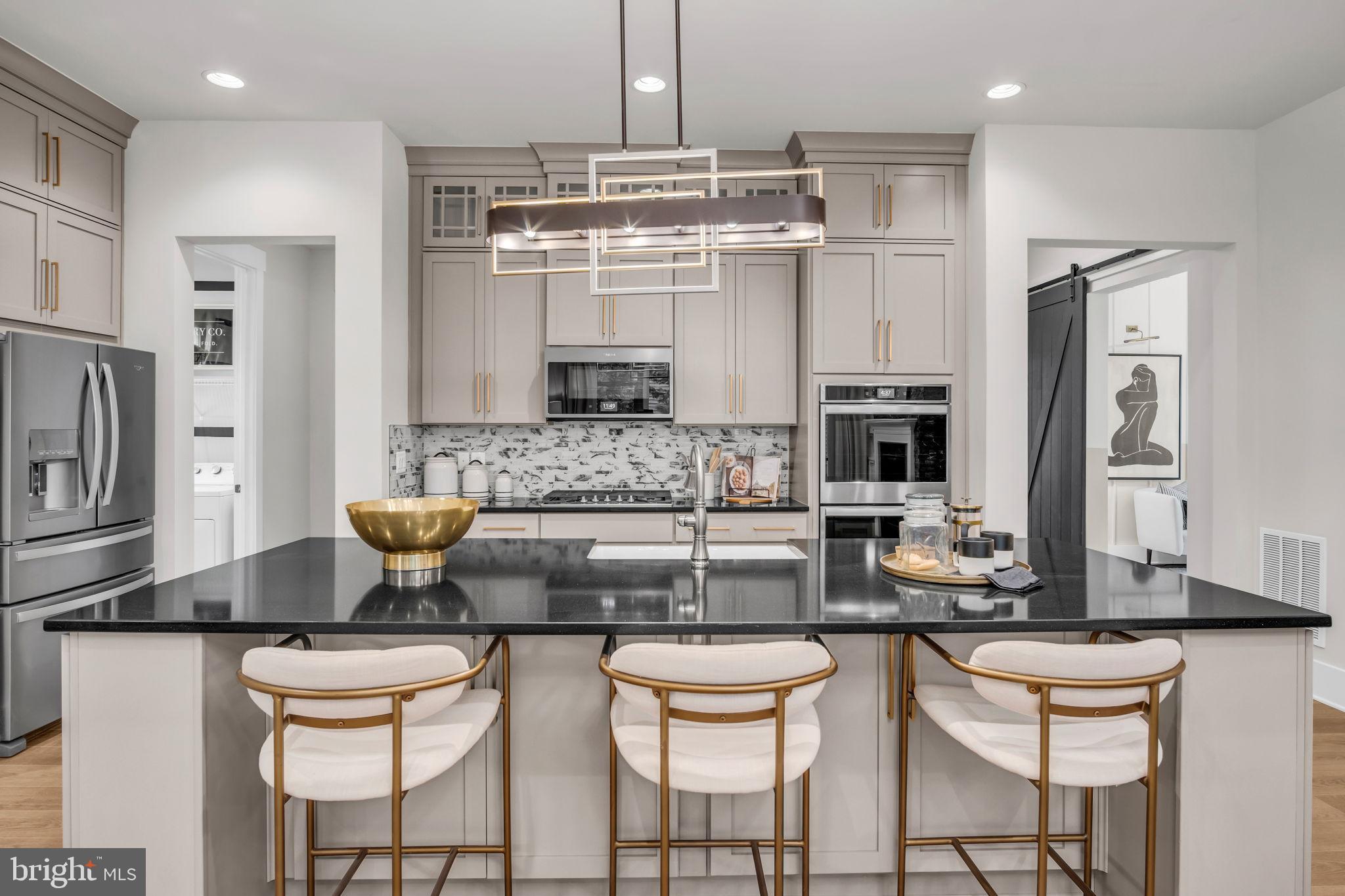 39 Reedgrass Way Gettysburg, PA 17325 - Photo 28 of 44 a kitchen with stainless steel appliances kitchen island granite countertop a table and chairs