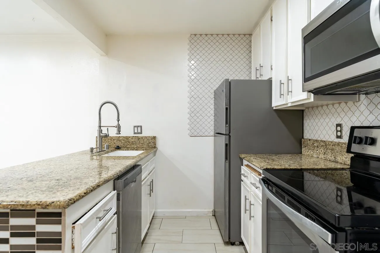 615 Vine Street, Unit 15 Oceanside, CA 92054 - Photo 3 of 23 a kitchen with stainless steel appliances granite countertop a sink stove and refrigerator