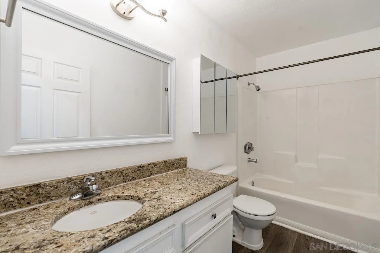 615 Vine Street, Unit 15 Oceanside, CA 92054 - Photo 10 of 23 a bathroom with a granite countertop sink toilet and shower