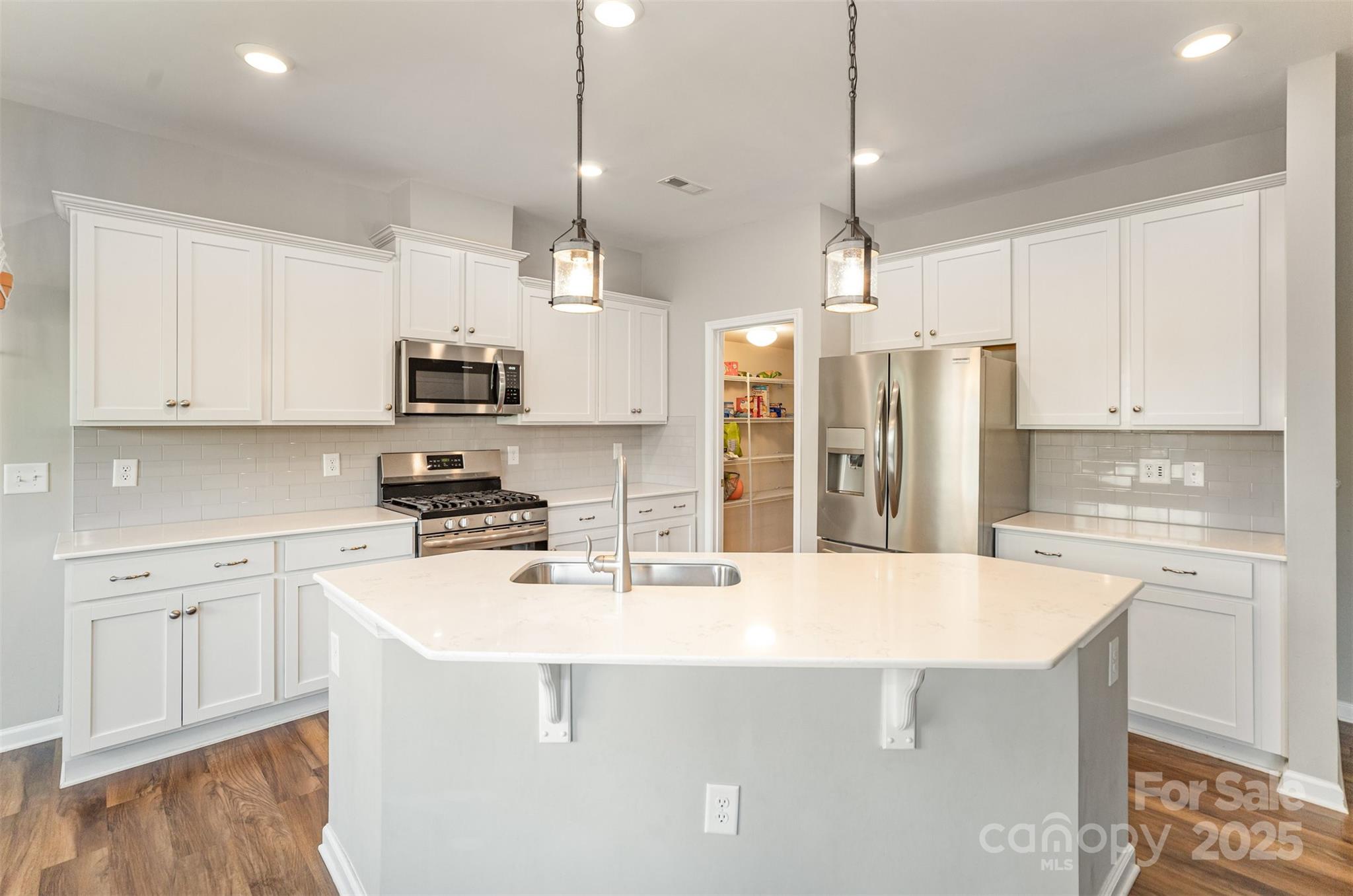 810 Braddock Way Fort Mill, SC 29715 - Photo 11 of 38 a kitchen with stainless steel appliances a refrigerator a stove a sink a center island and cabinets