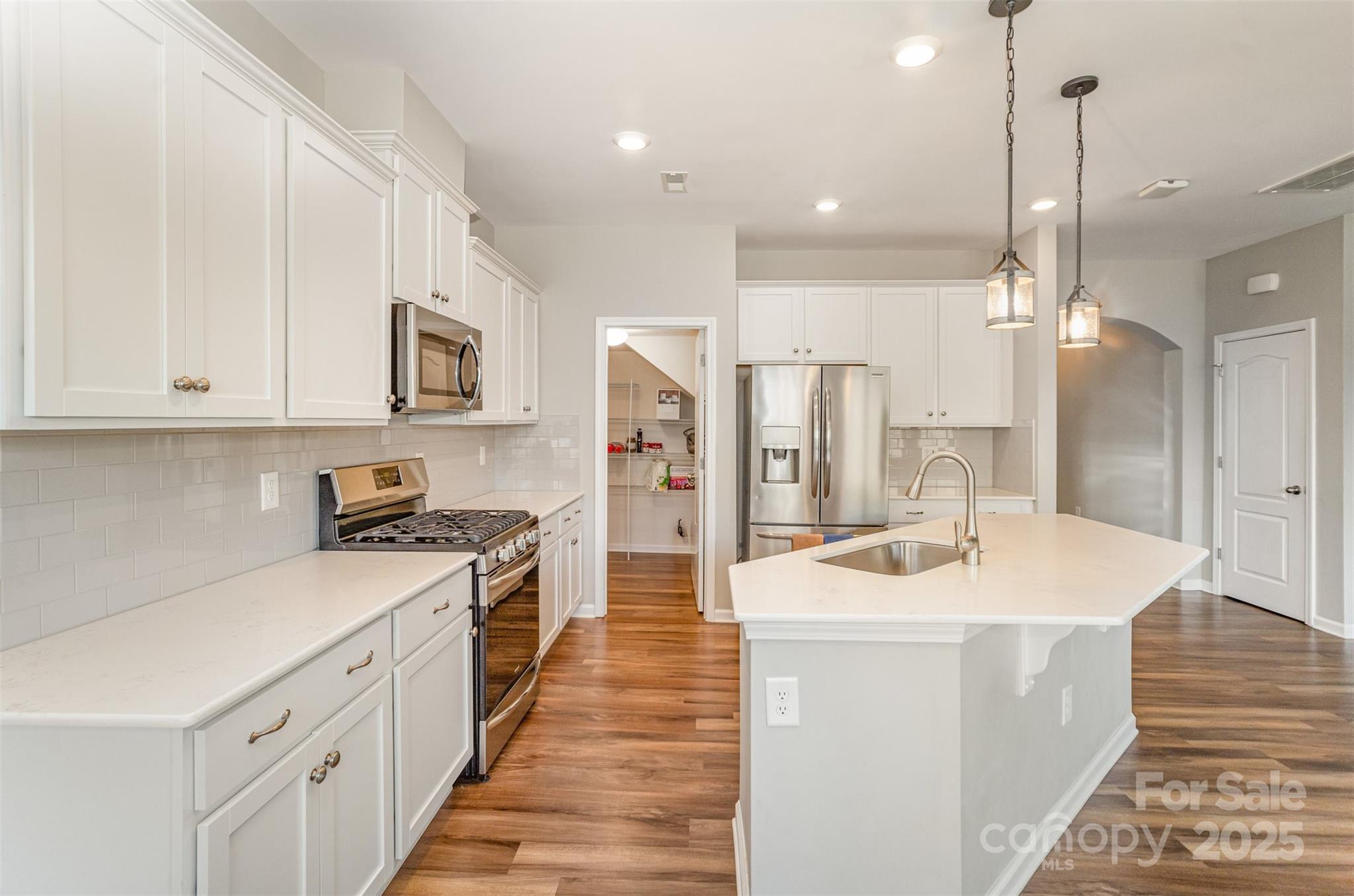 810 Braddock Way Fort Mill, SC 29715 - Photo 13 of 38 a kitchen with stainless steel appliances sink stove refrigerator and cabinets