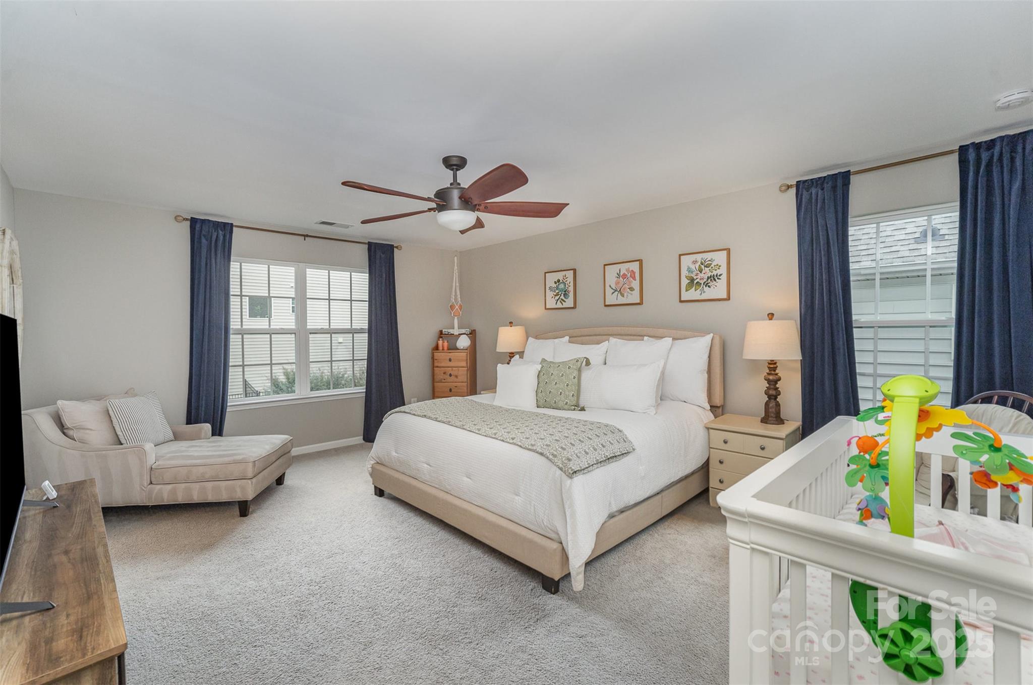 810 Braddock Way Fort Mill, SC 29715 - Photo 21 of 38 a spacious bedroom with a bed and a couch