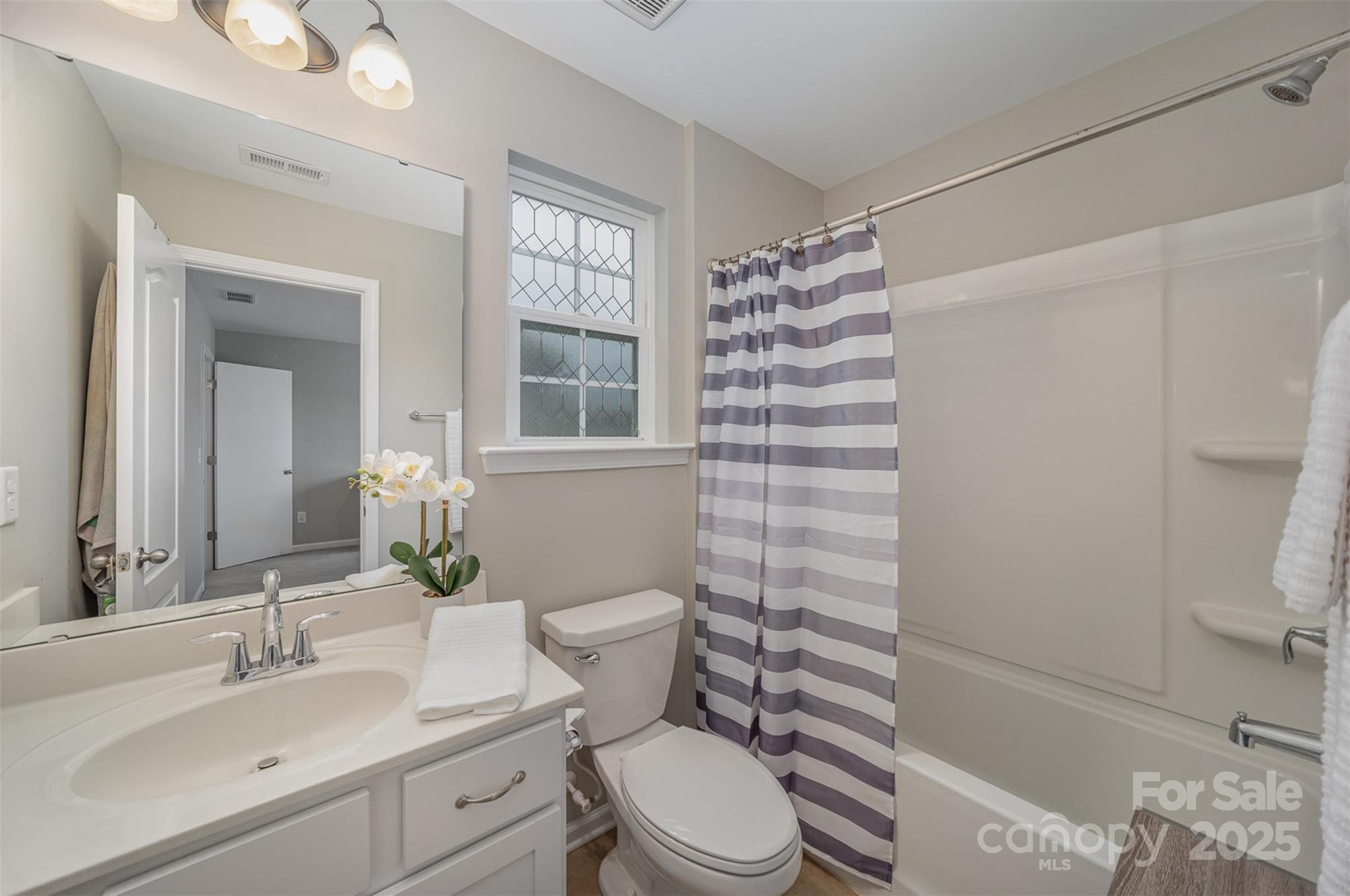 810 Braddock Way Fort Mill, SC 29715 - Photo 30 of 38 a bathroom with a sink toilet vanity and shower