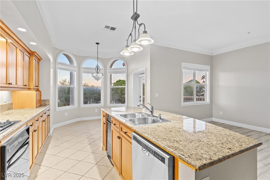 35 Strada Di Circolo Henderson, NV 89011 - Photo 12 of 28 Kitchen featuring crown molding, pendant lighting, dishwasher, oven, and light stone counters