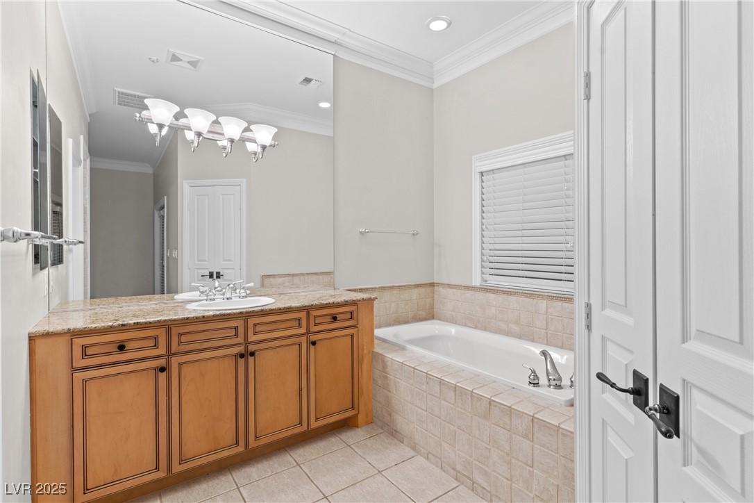35 Strada Di Circolo Henderson, NV 89011 - Photo 17 of 28 Full bathroom with crown molding, a bath, vanity, light tile patterned floors, and recessed lighting