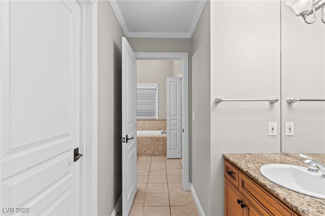 35 Strada Di Circolo Henderson, NV 89011 - Photo 21 of 28 Full bath with light tile patterned flooring, vanity, ornamental molding, and a bath
