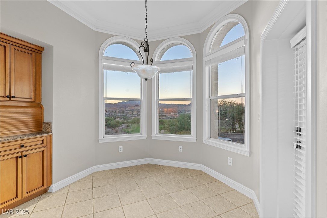35 Strada Di Circolo Henderson, NV 89011 - Photo 7 of 28 Unfurnished dining area featuring crown molding and light tile patterned floors