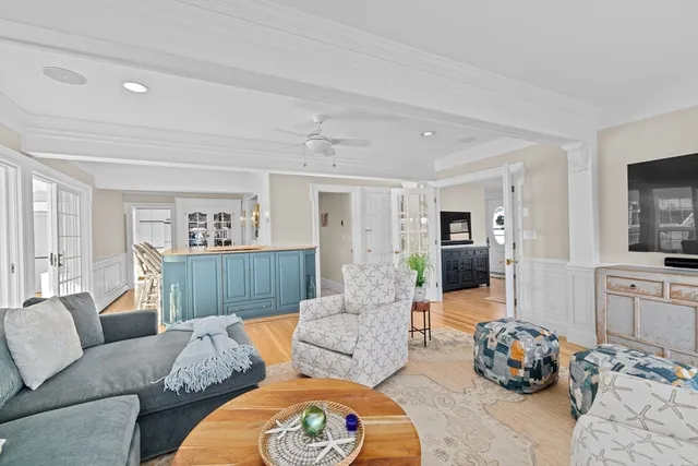 a living room with furniture wooden floor and a flat screen tv