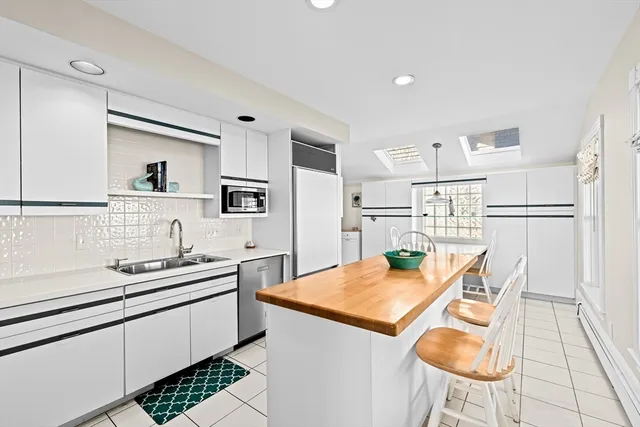 a kitchen with stainless steel appliances kitchen island granite countertop a sink and cabinets