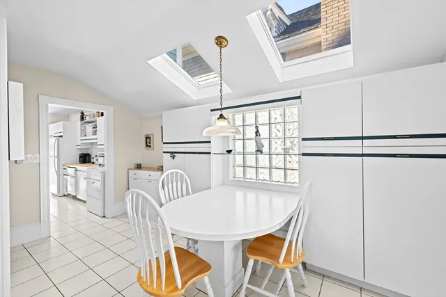 a dining room with furniture and window