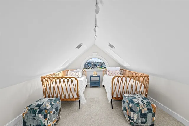 a bedroom with two beds and a chair