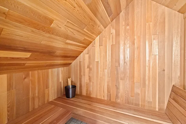 a view of a closet with wooden walls