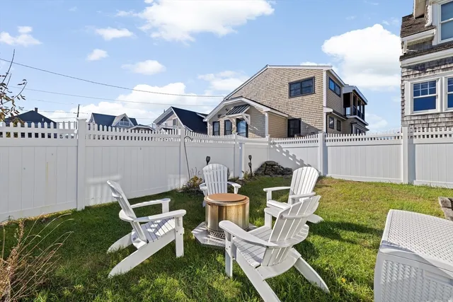 a front view of a house with a yard table and chairs