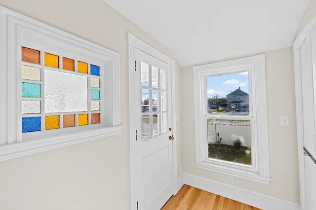 a view of an entryway with wooden floor