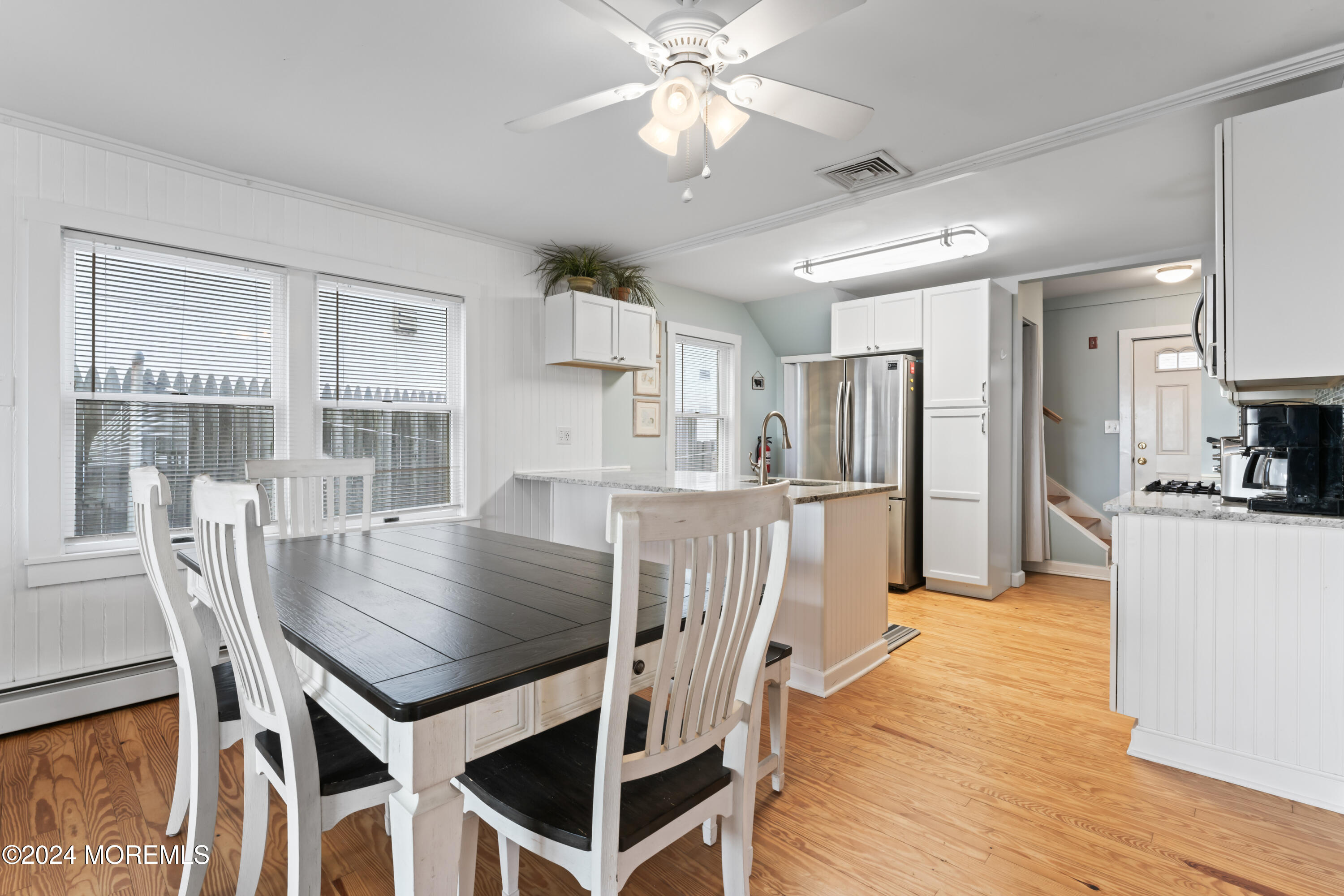 255 Boardwalk Point Pleasant Beach, NJ 08742 - Photo 13 of 34 a view of a dining room with furniture and wooden floor
