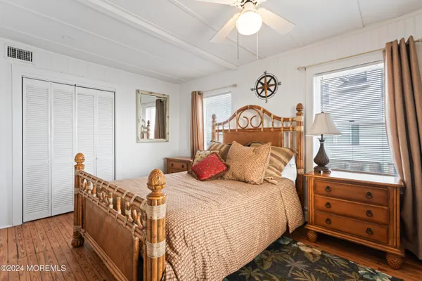 a bedroom with a large bed and a chandelier