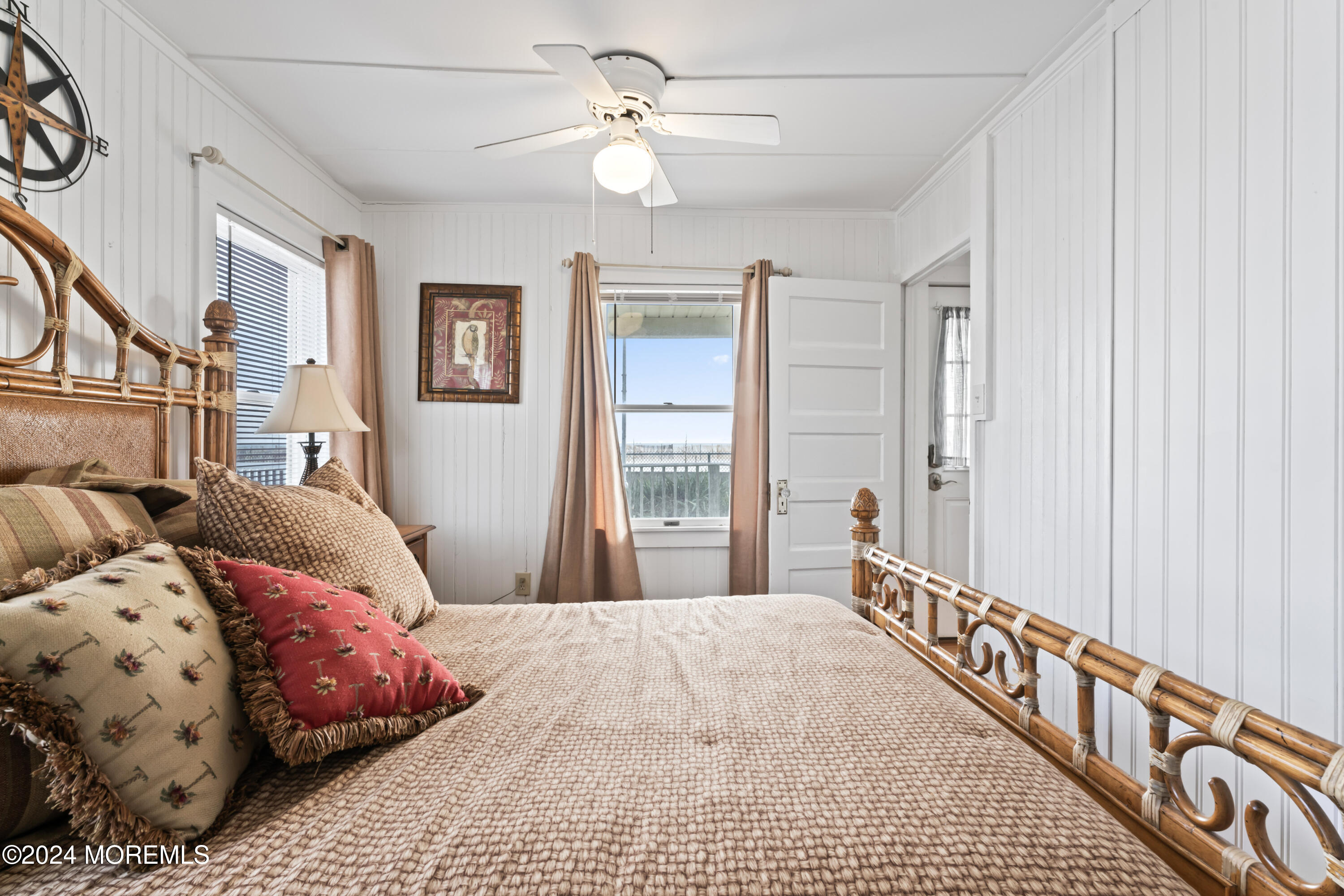 255 Boardwalk Point Pleasant Beach, NJ 08742 - Photo 15 of 34 a bedroom with a large bed and a chandelier