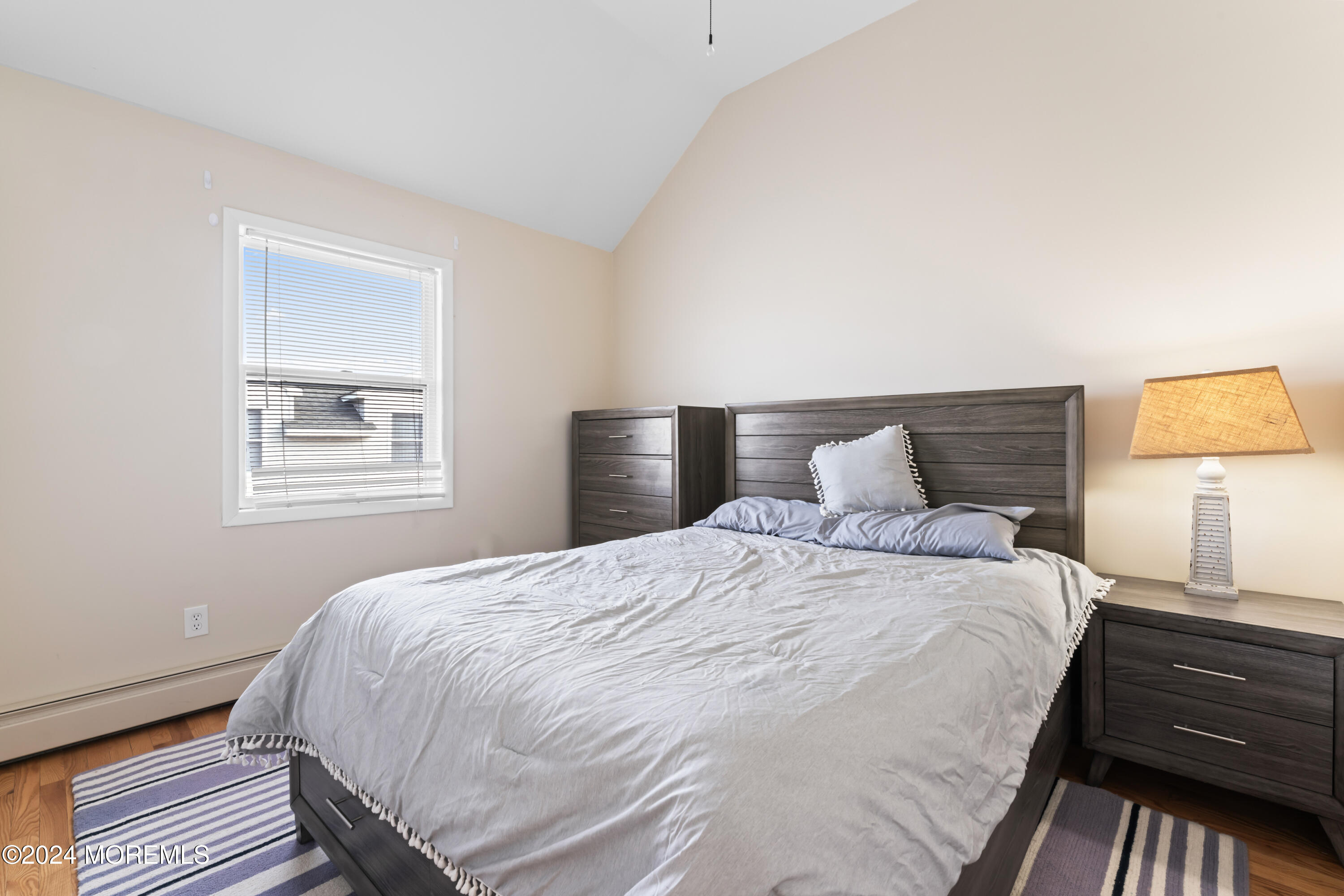 255 Boardwalk Point Pleasant Beach, NJ 08742 - Photo 20 of 34 a bedroom with a bed and wooden floor
