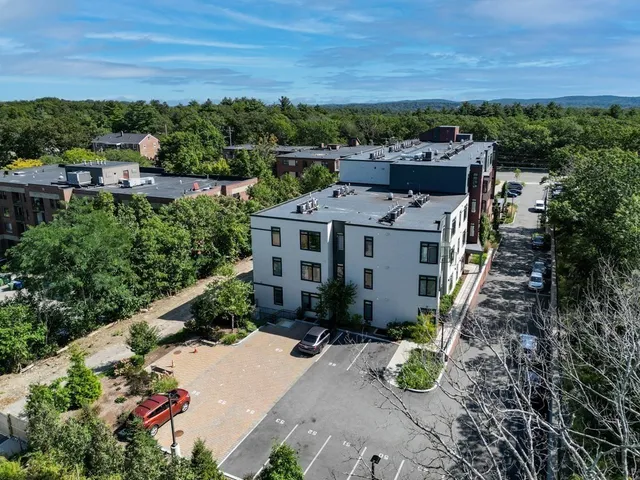 an aerial view of a house with a yard