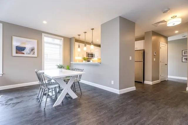 a view of a dining room with furniture and a window