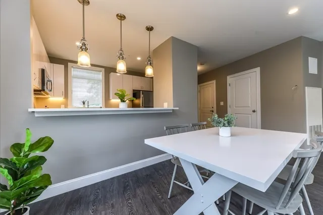 a view of a dining room with a table and chairs