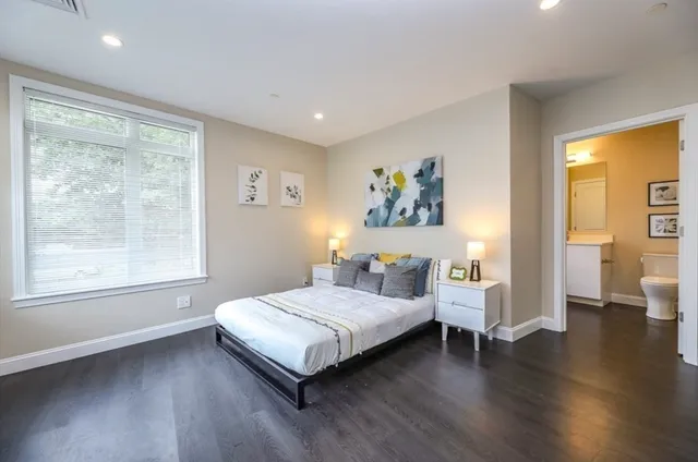 a bedroom with a bed and a large window