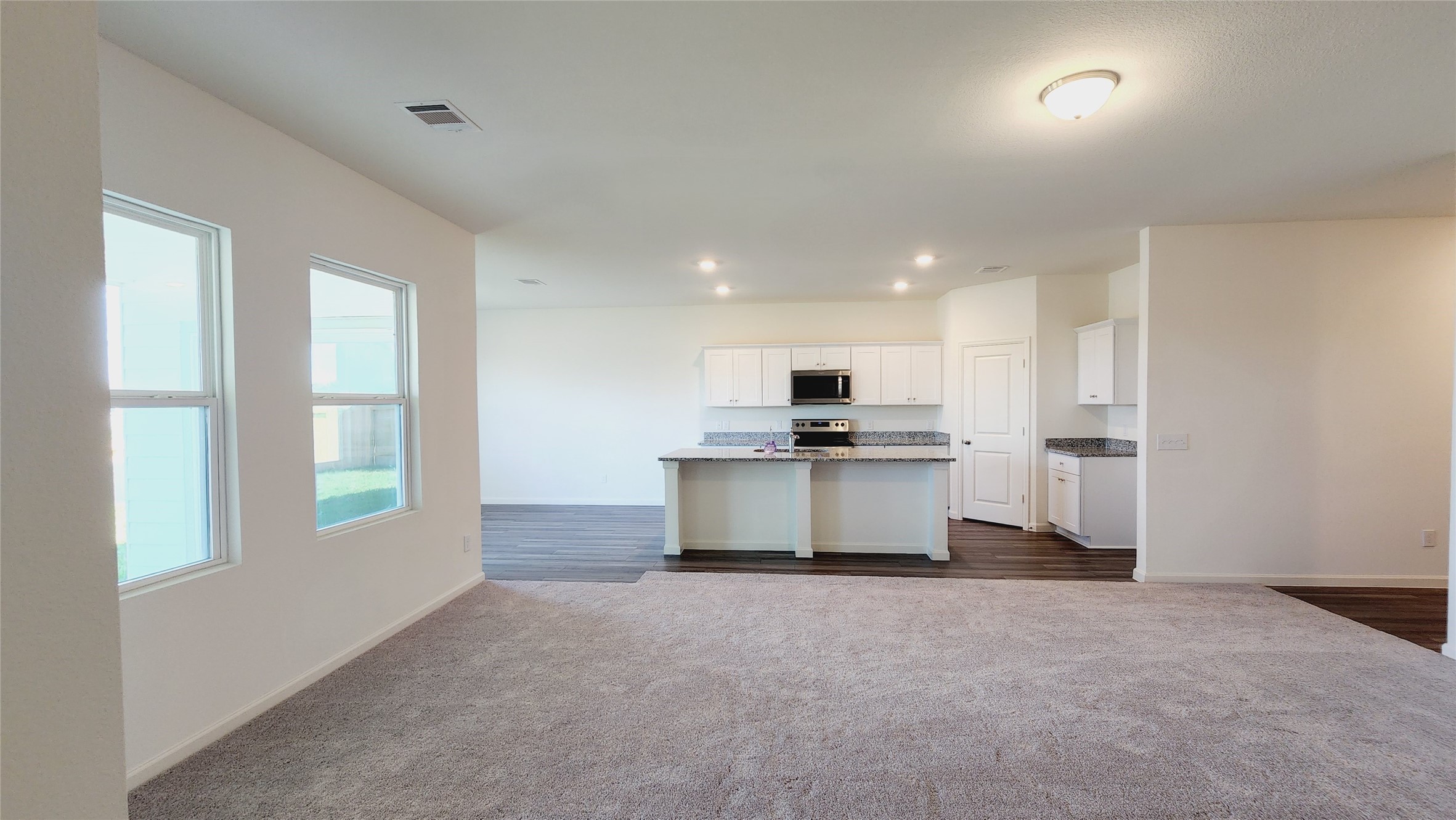 6339 Highland Trl Drive Richmond, TX 77469 - Photo 13 of 28 a view of kitchen with kitchen island granite countertop a stove a sink a refrigerator and white cabinets with wooden floor